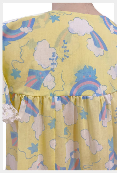 1970s yellow novelty print nightgown with rainbows, clouds, kites and suns | size small
